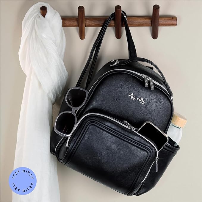 Itzy Ritzy Mini Diaper Bag Backpack – Chic, Compact Mini Plus Backpack with Changing Pad, 10 Pockets (6 Internal, 4 External), Grab-Top Handle & Rubber Feet (Black w/Silver Hardware)