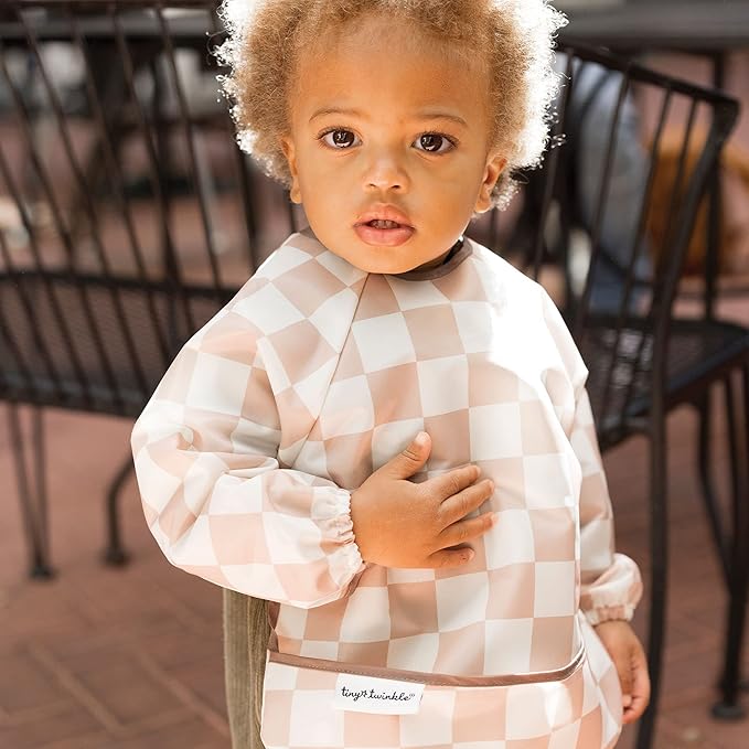 Tiny Twinkle Long Sleeve Bib for Babies & Toddlers | Waterproof Smock Bib for Eating | Machine Washable & Mess-Proof Feeding Essentials | Newborn Shower Gift (Checkers Brown, 6–24M)